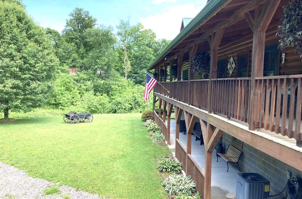 photo of two story covered porch and decking that runs the entire lenghth of the home
